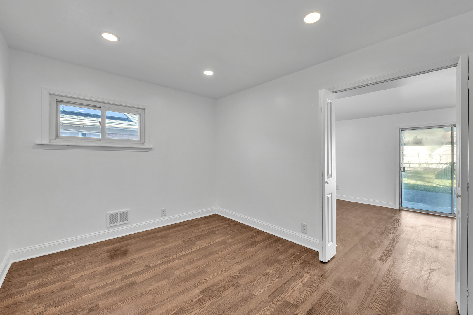 7817 South Kenton Avenue Chicago, IL 60652 - Photo 13 of 29 an empty room with wooden floor and windows
