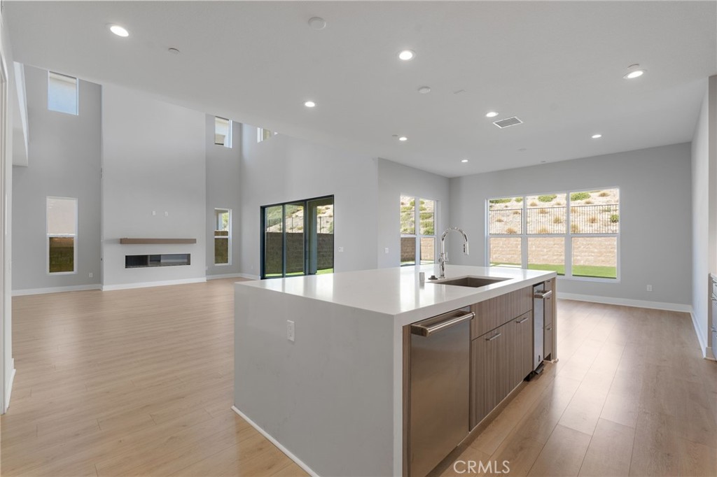 20637 West Hummingbird Porter Ranch Porter Ranch, CA 91326 - Photo 15 of 53 a large kitchen with stainless steel appliances granite countertop a sink and cabinets with wooden floor