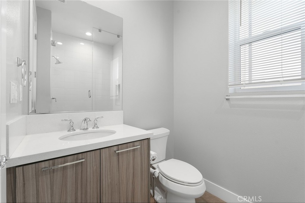 20637 West Hummingbird Porter Ranch Porter Ranch, CA 91326 - Photo 24 of 53 a bathroom with a sink vanity mirror and toilet