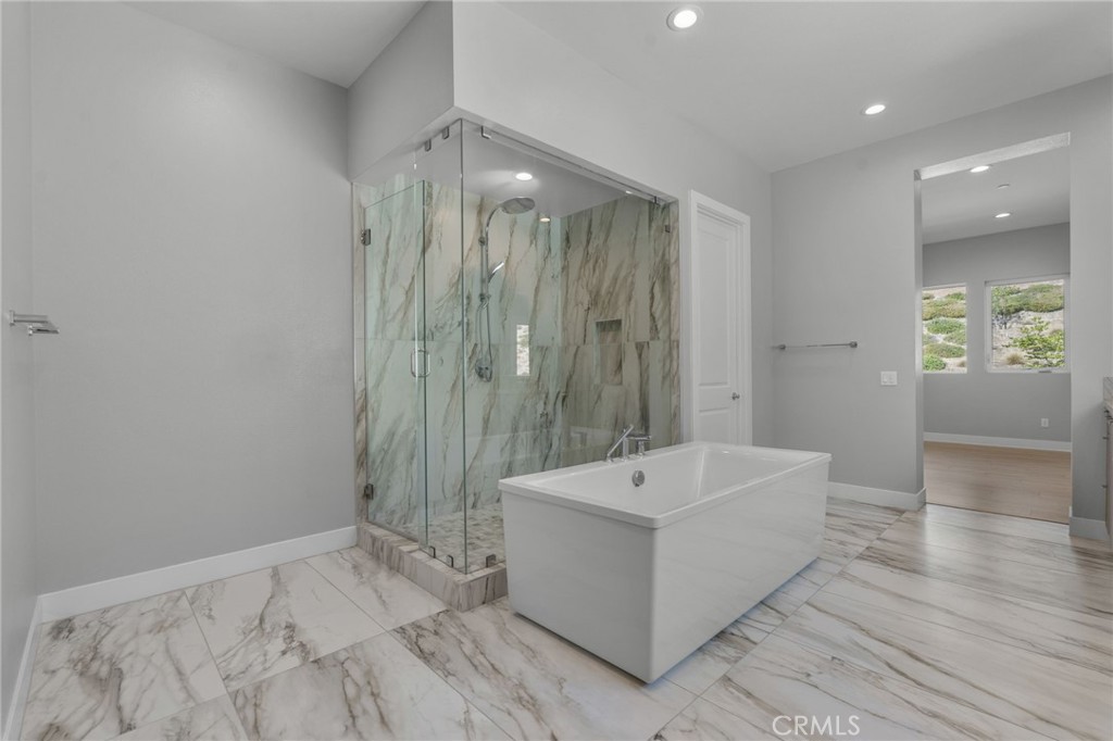 20637 West Hummingbird Porter Ranch Porter Ranch, CA 91326 - Photo 31 of 53 a spacious bathroom with a tub shower and sink