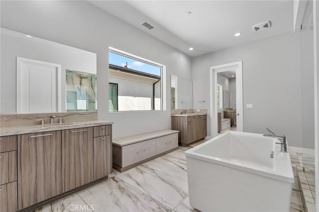 20637 West Hummingbird Porter Ranch Porter Ranch, CA 91326 - Photo 32 of 53 a bathroom with a tub a sink and mirror