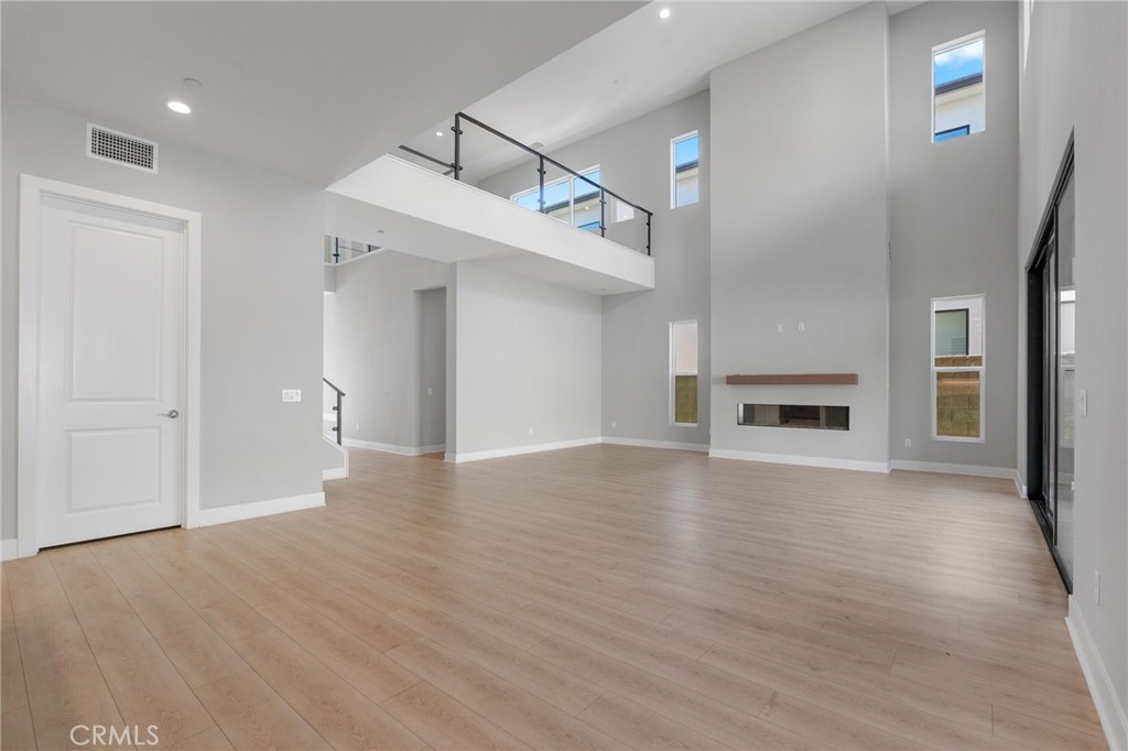 20637 West Hummingbird Porter Ranch Porter Ranch, CA 91326 - Photo 6 of 53 a view of empty room with wooden floor and fireplace