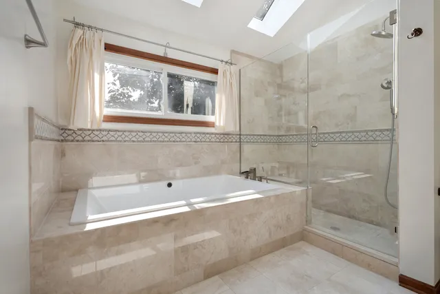 a bathroom with a tub and a shower