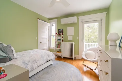 a bedroom with a bed and a large window