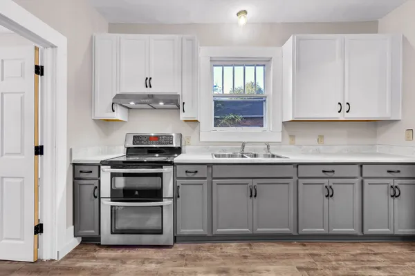 a kitchen with stainless steel appliances granite countertop a stove and a sink