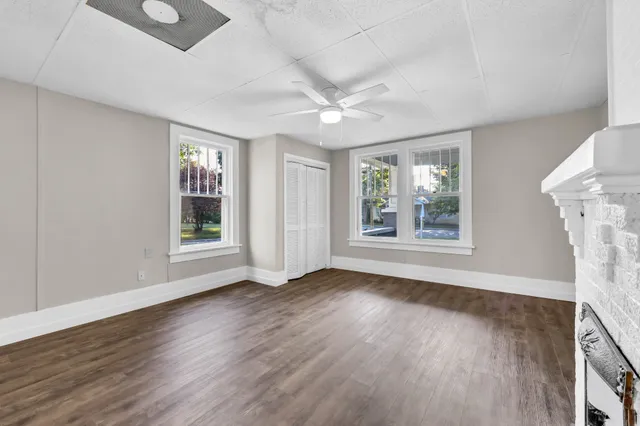 wooden floor in an empty room with a window