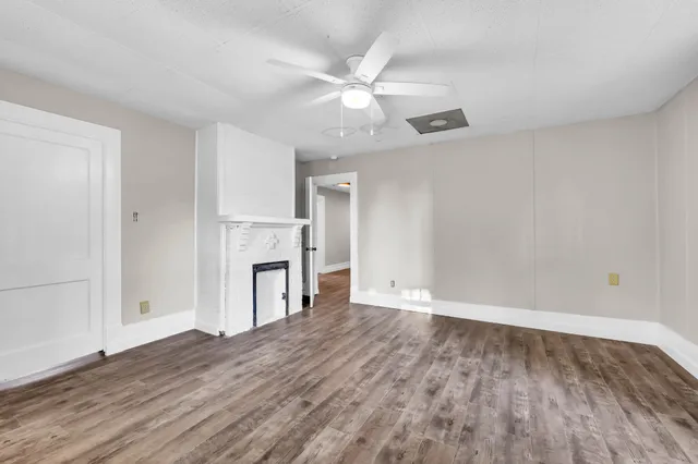 wooden floor in an empty room with a fireplace