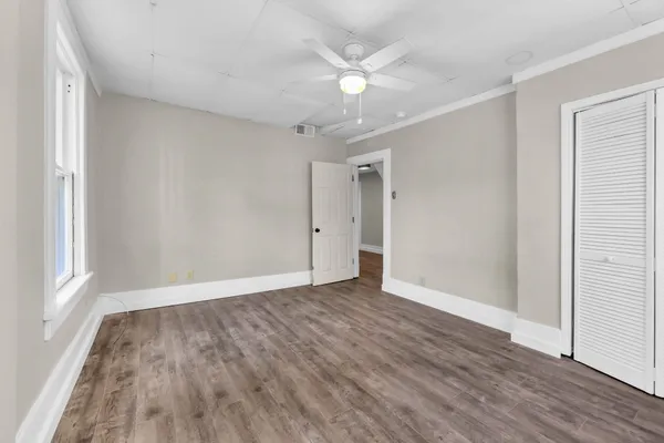 wooden floor in an empty room with a window