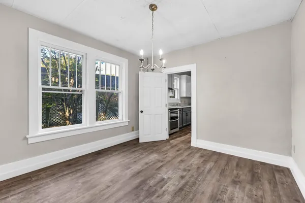 a view of a room with windows and chandelier