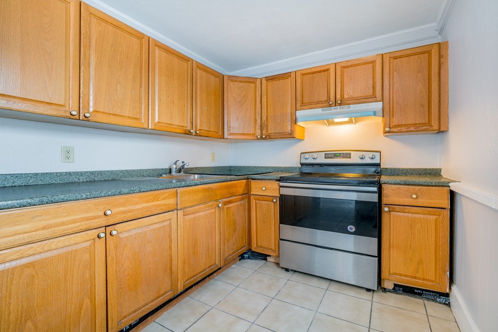 391 Concord Street Framingham, MA 01702 - Photo 11 of 27 a kitchen with granite countertop cabinets stainless steel appliances and a sink