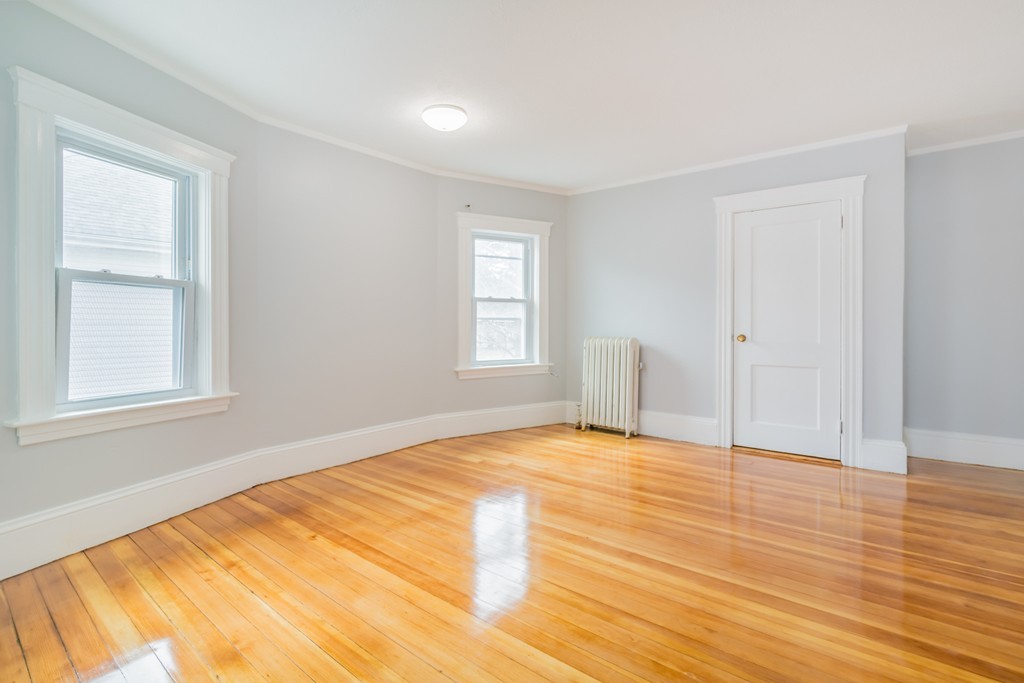 391 Concord Street Framingham, MA 01702 - Photo 14 of 27 a view of an empty room with wooden floor and a window