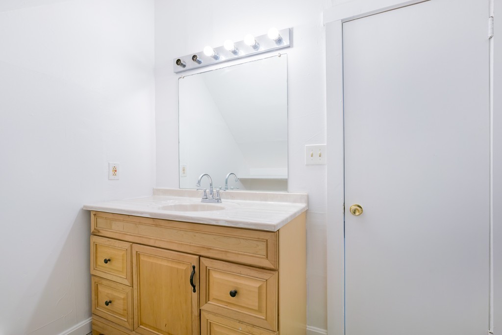 391 Concord Street Framingham, MA 01702 - Photo 18 of 27 a bathroom with a sink and a mirror