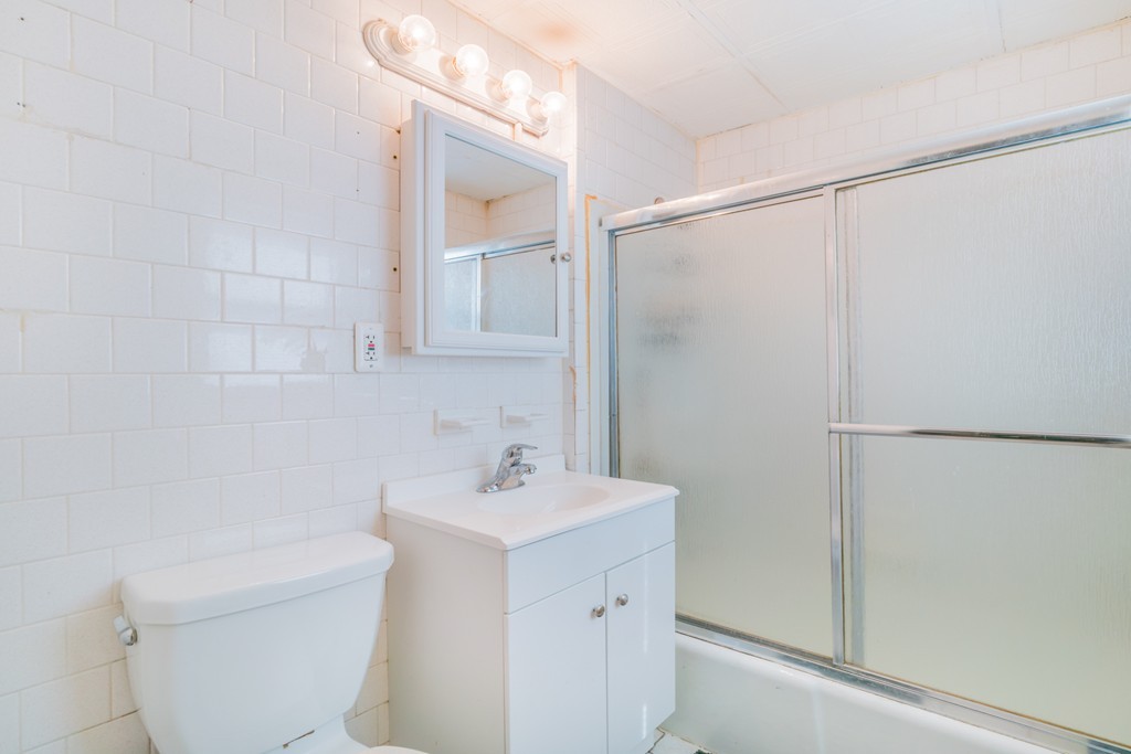 391 Concord Street Framingham, MA 01702 - Photo 20 of 27 a bathroom with a sink a toilet and shower