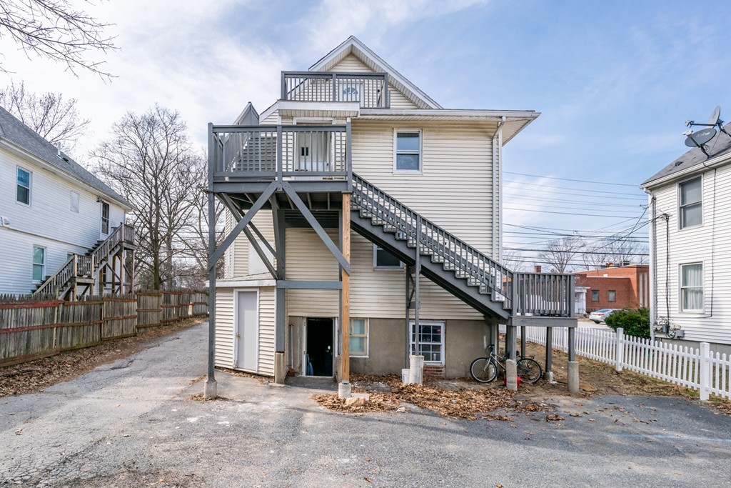 391 Concord Street Framingham, MA 01702 - Photo 2 of 27 a view of a house with wooden fence