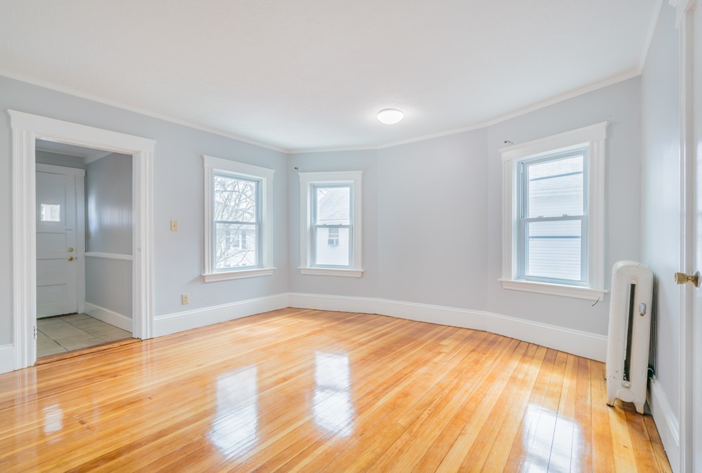 391 Concord Street Framingham, MA 01702 - Photo 5 of 27 a view of empty room with wooden floor and fan