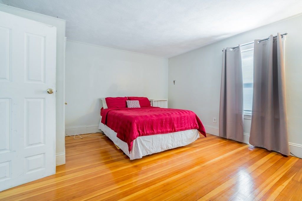391 Concord Street Framingham, MA 01702 - Photo 10 of 27 a bedroom with a bed and wooden floor