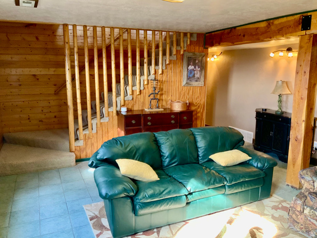 76 Highway 118 Monroe, UT 84754 - Photo 58 of 76 Living room featuring wooden walls, stairs, and tile patterned floors