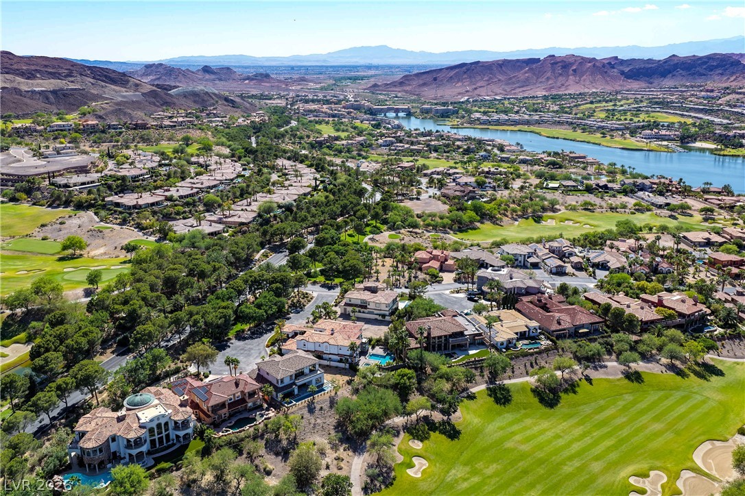 6 Rue Du Ville Henderson, NV 89011 - Photo 94 of 99 This elevated view captures a vibrant community with lush landscapes, serene waters, and mountain backdrops.