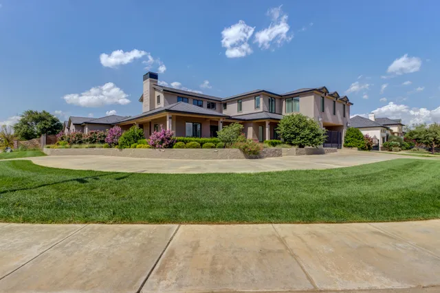 a front view of a house with a yard and a garage