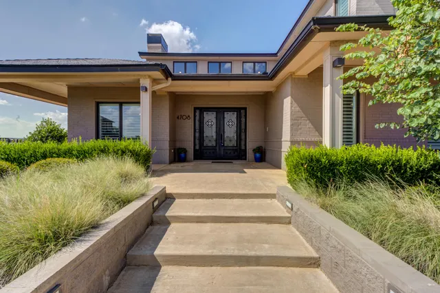 a living room with furniture potted plant and a large window