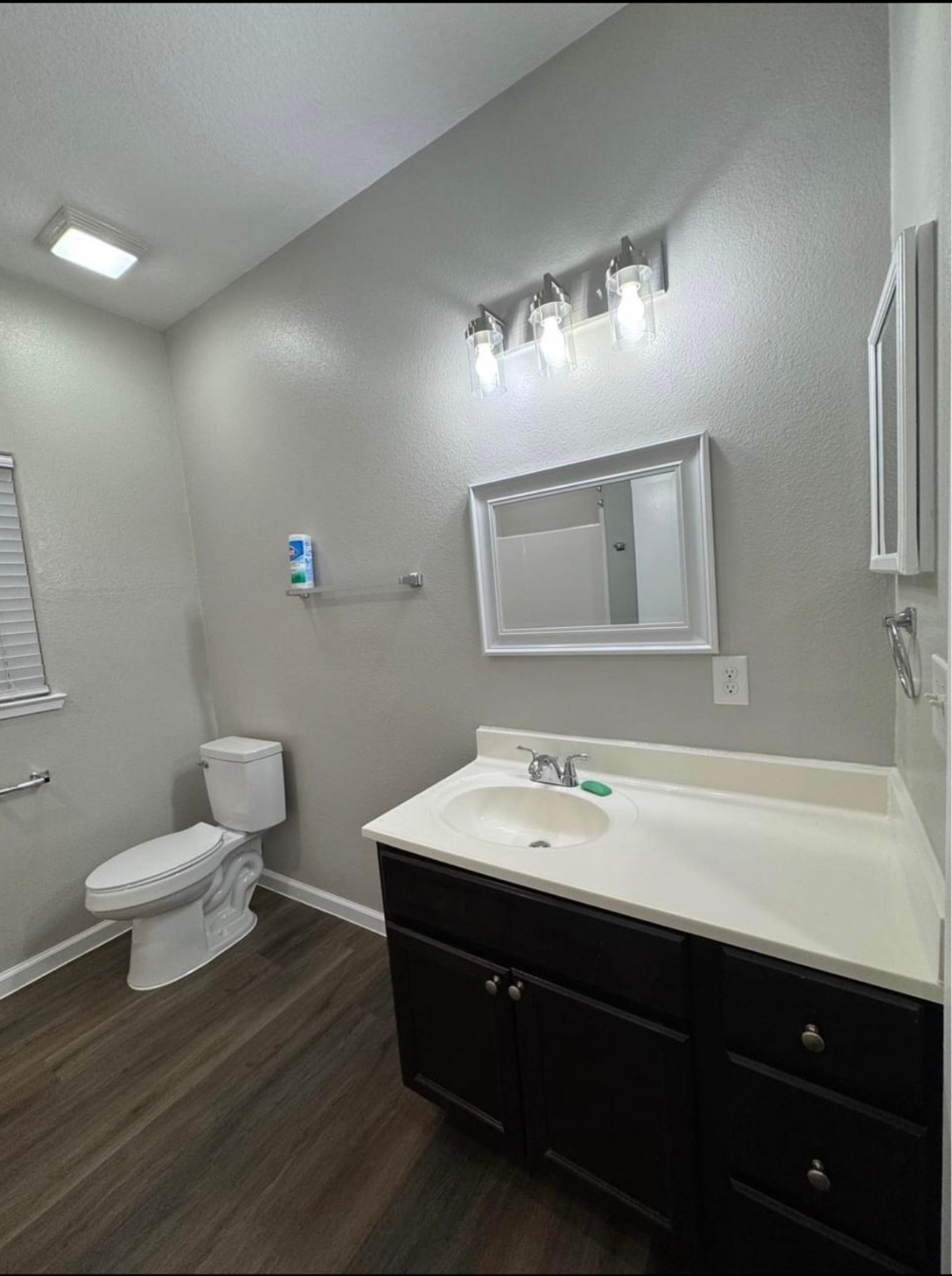 4741 Providence Street Houston, TX 77020 - Photo 16 of 22 a bathroom with a sink a toilet and mirror