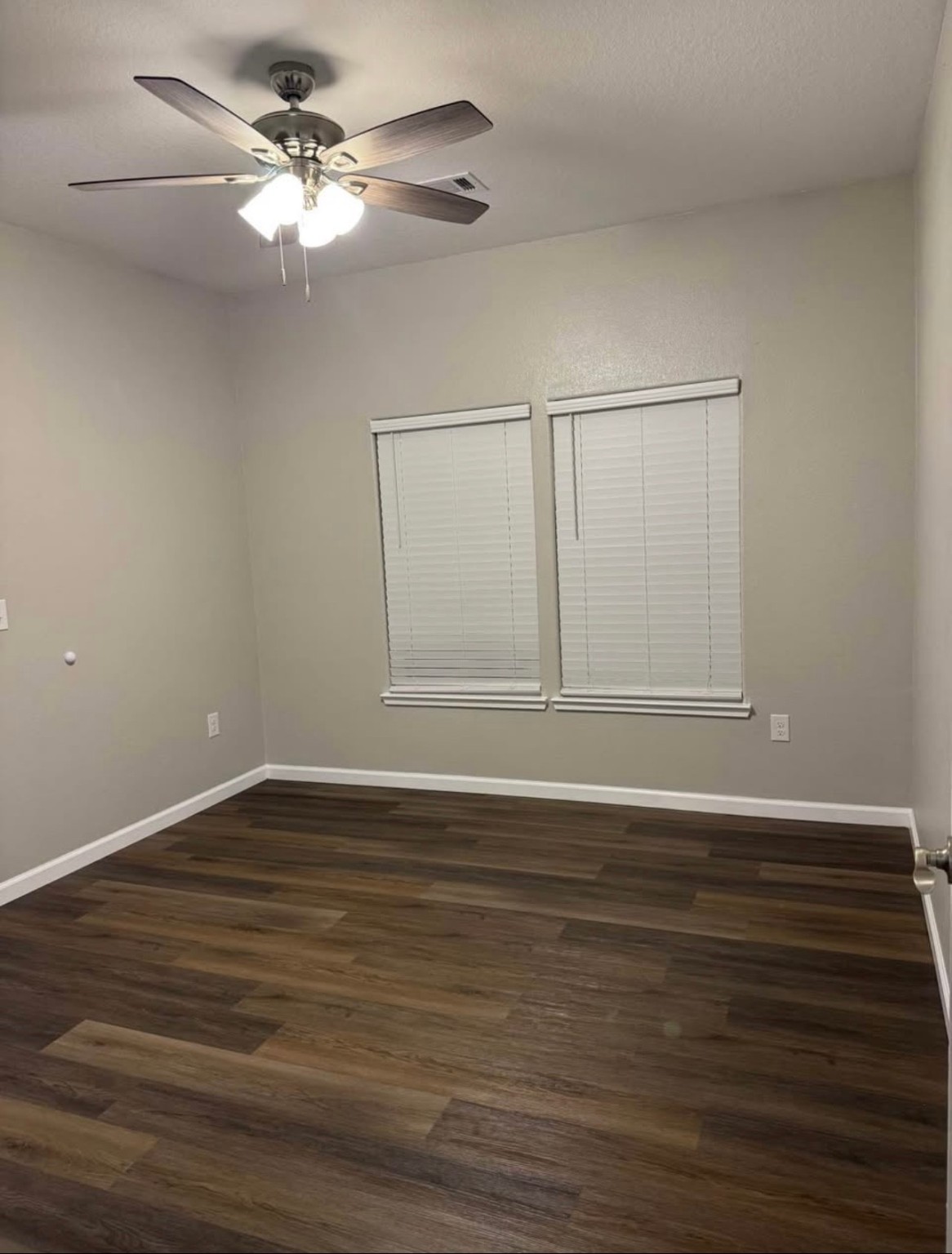 4741 Providence Street Houston, TX 77020 - Photo 20 of 22 a view of an empty room with wooden floor and a ceiling fan