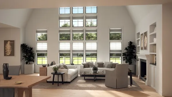 a living room with furniture and floor to ceiling windows
