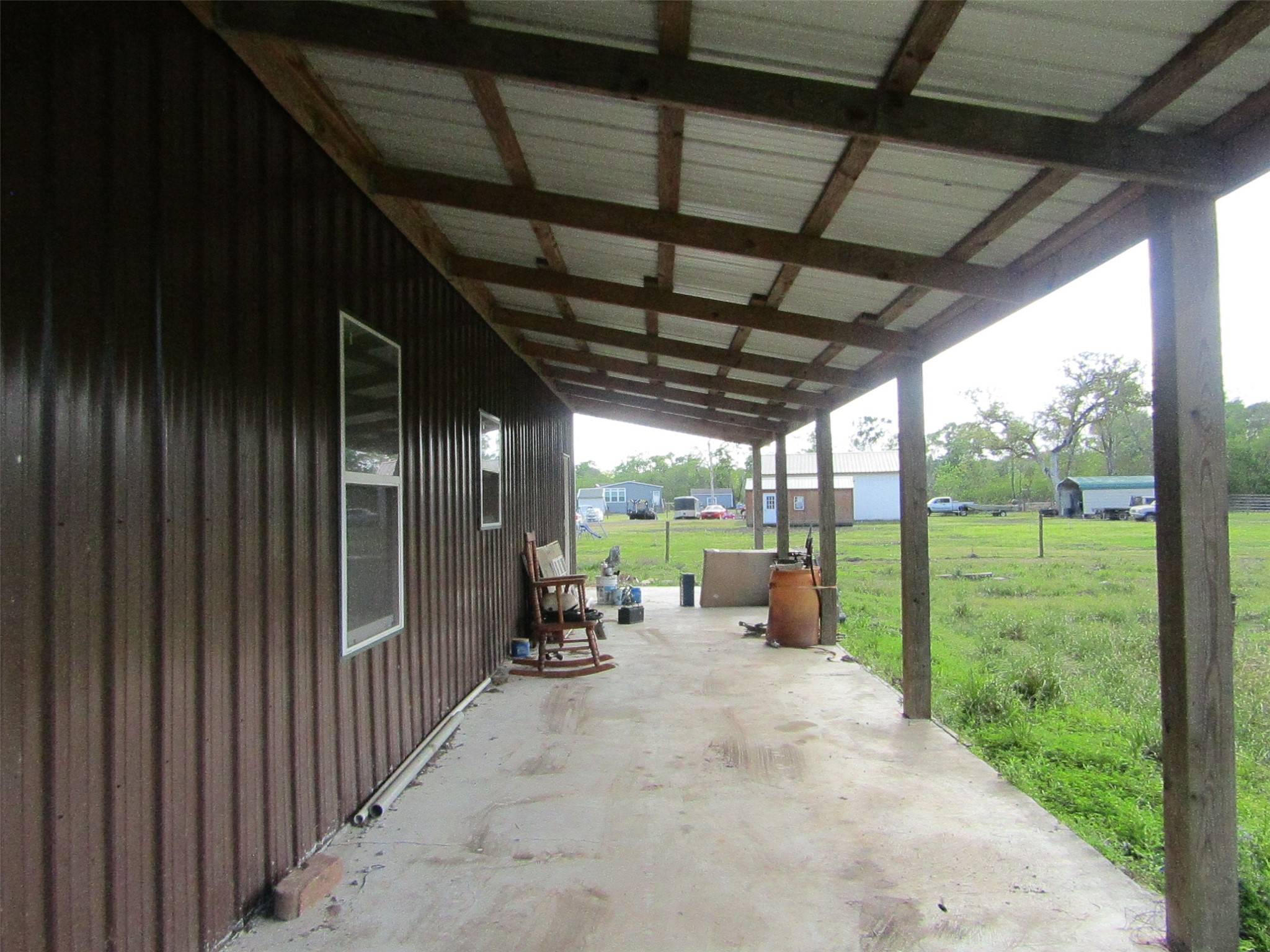 7072 County Road 3 Sweeny, TX 77480 - Photo 23 of 23 a view of a porch with chairs and backyard