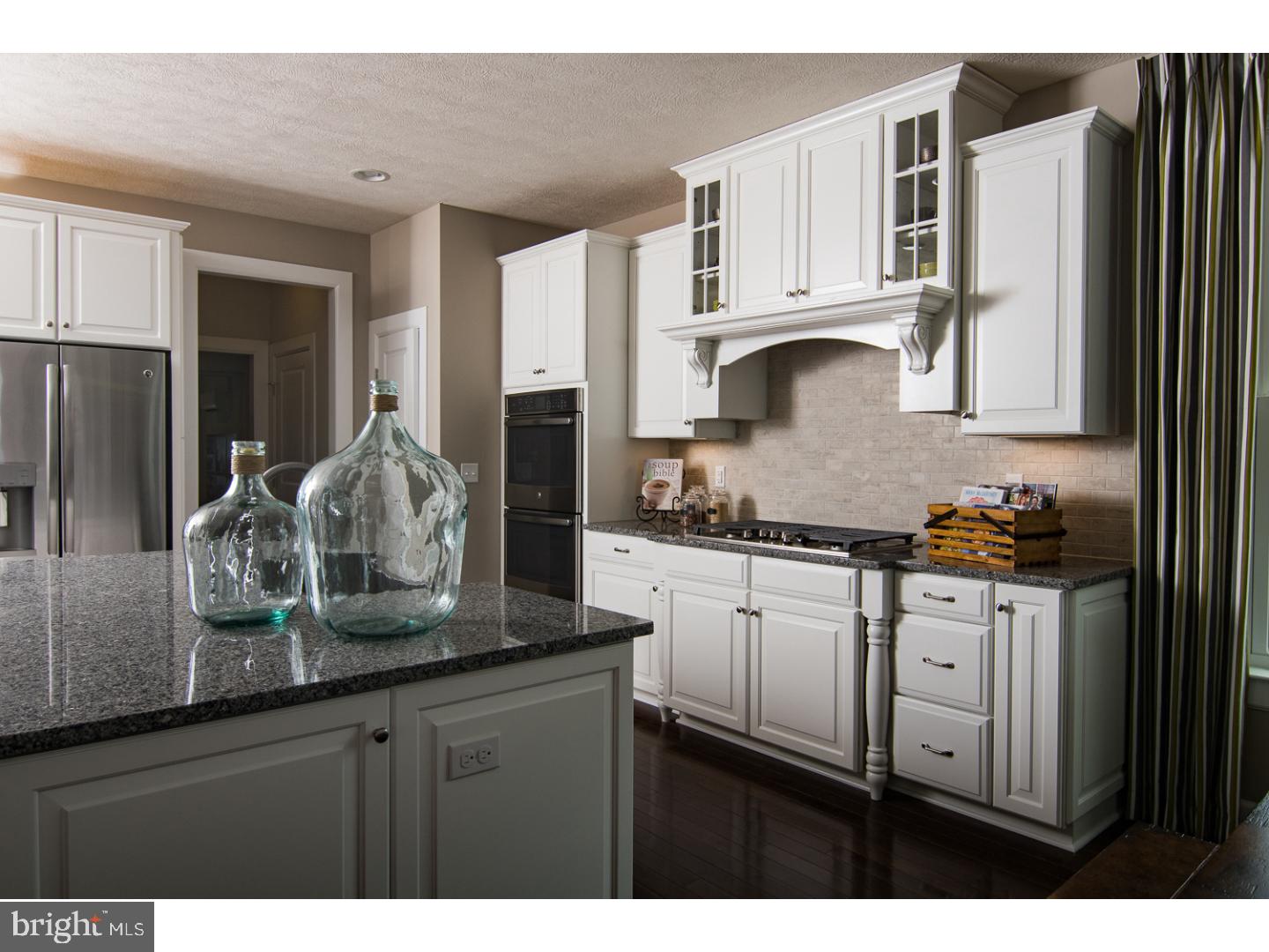 724 Stonecliffe Road Malvern, PA 19355 - Photo 2 of 10 a kitchen with stainless steel appliances granite countertop a sink stove and refrigerator