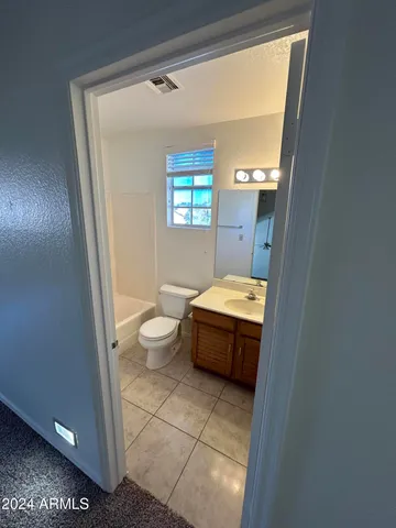 a bathroom with a toilet a sink and a mirror