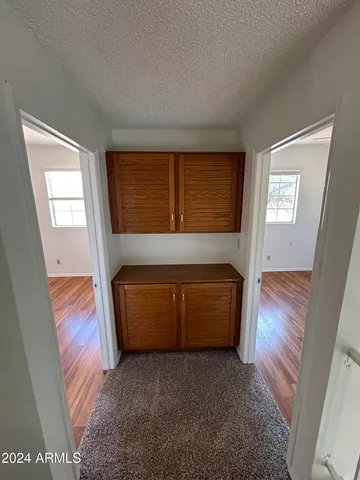 a living room with a couch and a dresser next to a window