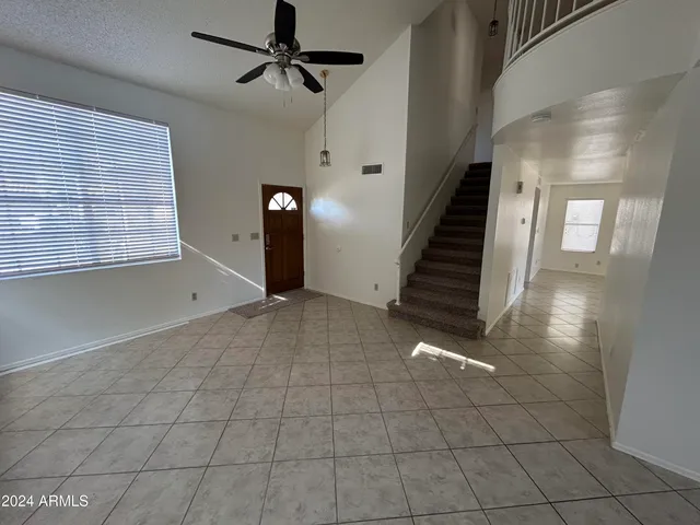 a view of a livingroom with wooden floor and stairs