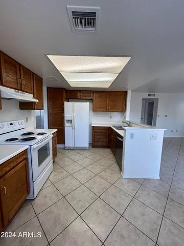 a kitchen with stainless steel appliances a stove a sink and a refrigerator