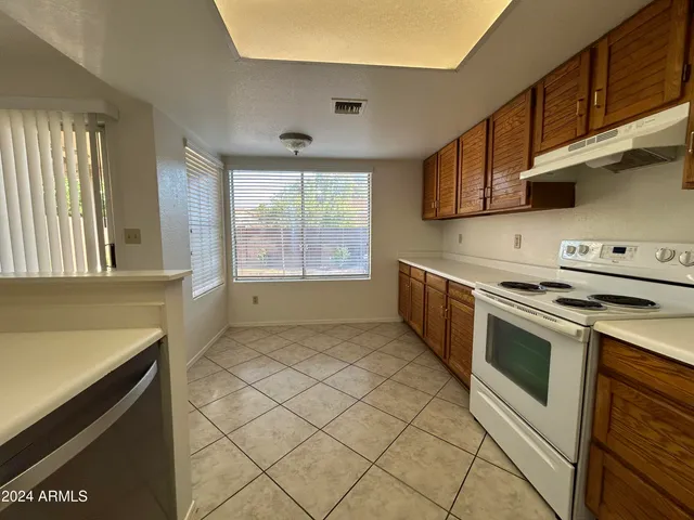 a kitchen with stainless steel appliances a stove a sink and a microwave
