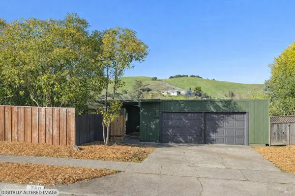 a view of a house with a yard and large tree