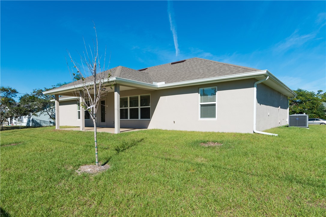 1361 Seahouse Street Sebastian, FL 32958 - Photo 12 of 13 a view of a house with a yard