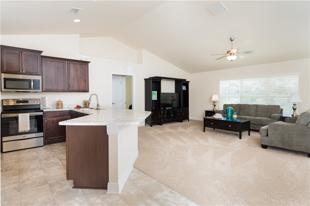 1361 Seahouse Street Sebastian, FL 32958 - Photo 6 of 13 a living room with furniture and a flat screen tv