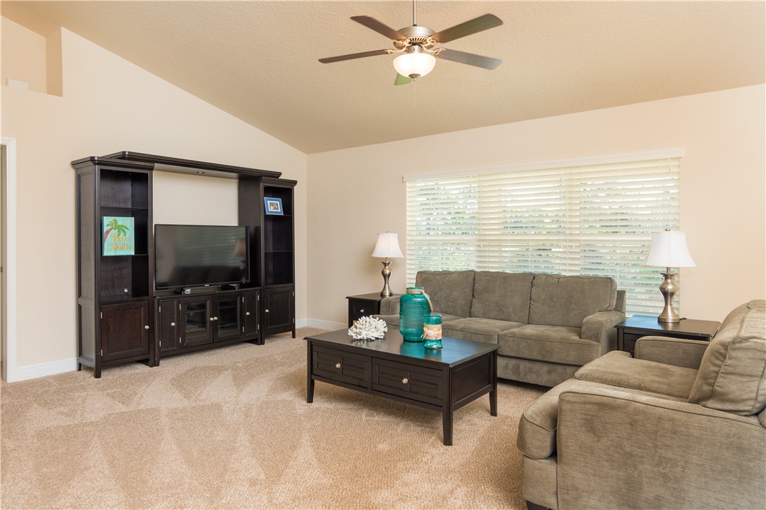1361 Seahouse Street Sebastian, FL 32958 - Photo 7 of 13 a living room with furniture and a flat screen tv