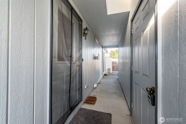 a view of hallway with stainless steel appliances granite countertop furniture