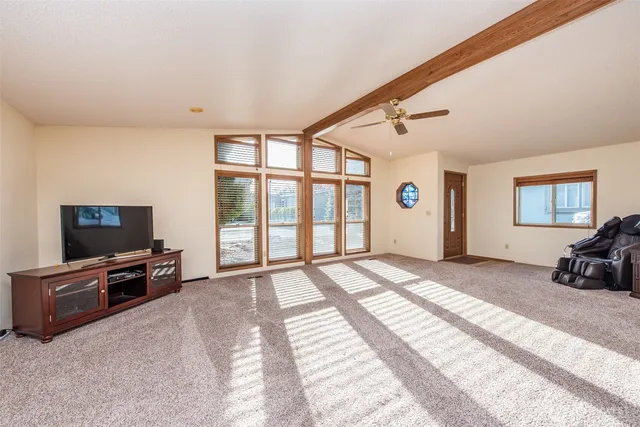 a view of a bedroom with furniture and windows