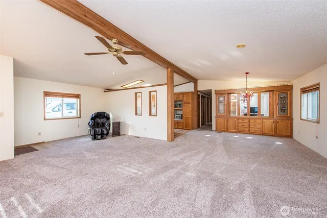 a view of a livingroom with an entryway and a window