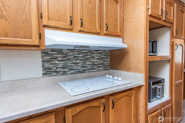 a view of kitchen cabinets and window