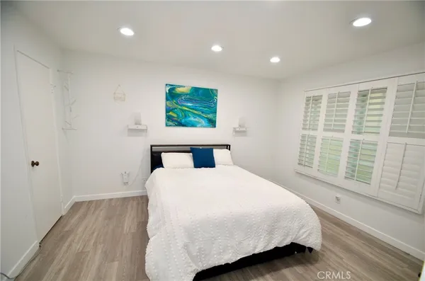 a bedroom with a bed and a large window