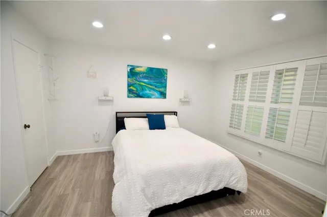 a bedroom with a bed and a large window