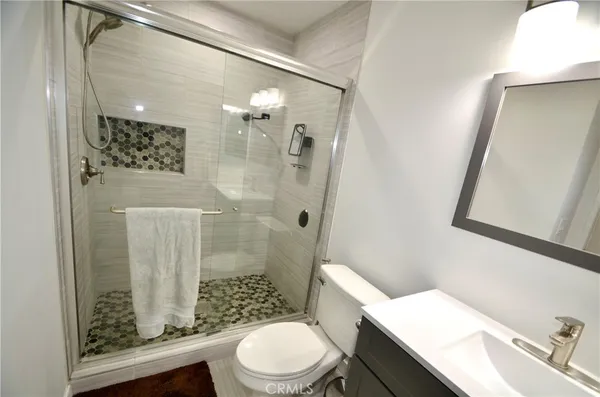 a white toilet sitting next to a bathroom sink