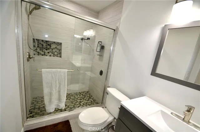 a white toilet sitting next to a bathroom sink