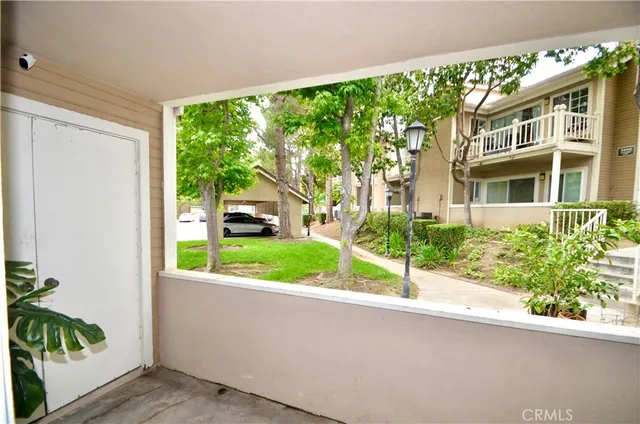 a view of a house with a garden and pathway