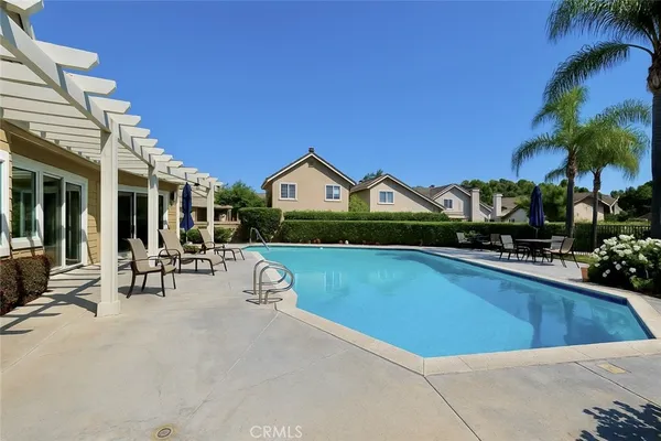 a view of house with swimming pool outdoor seating