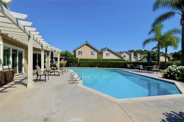 a view of house with swimming pool outdoor seating