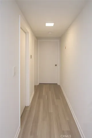 a view of a room with wooden floor and a window